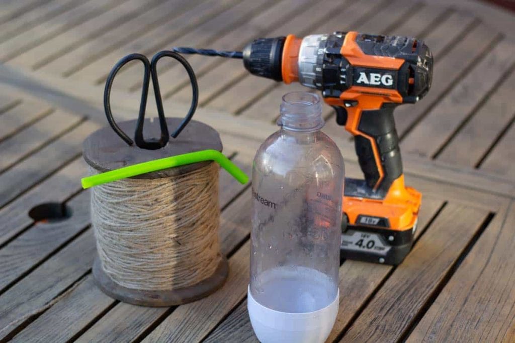 a plastic bottle, straw, string and a power drill