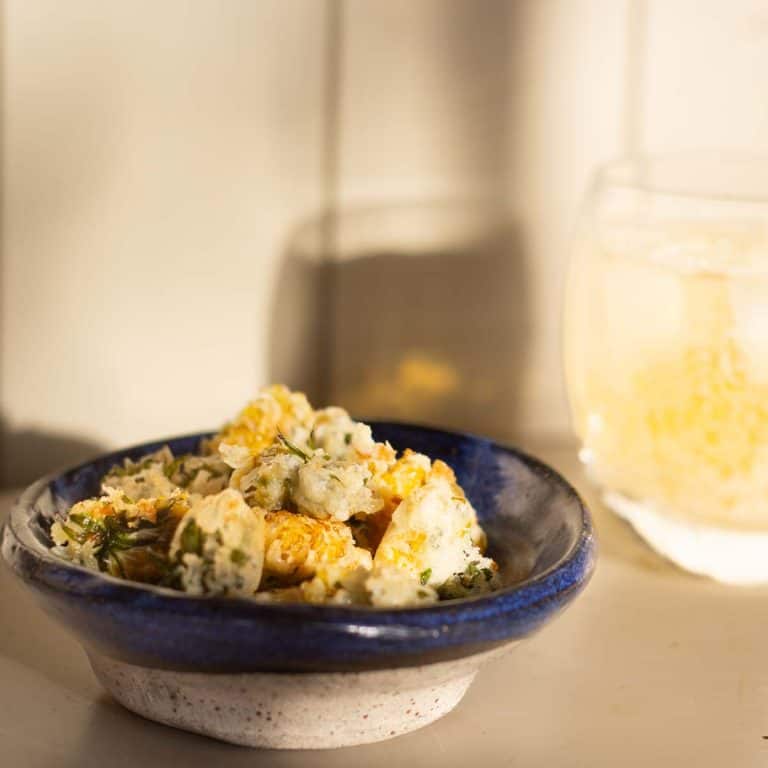 dandelion fritters in a pottery bowl
