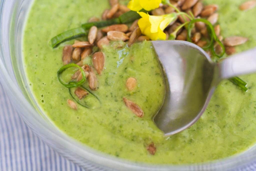 a close up image of a spoon in a small bowl of chilled sorrel soup