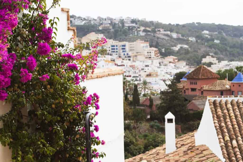 A view of a spanish village with mountains in the background