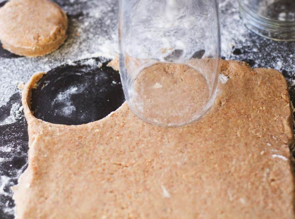 Rim of a glas cutting cookie shapes from cookie dough