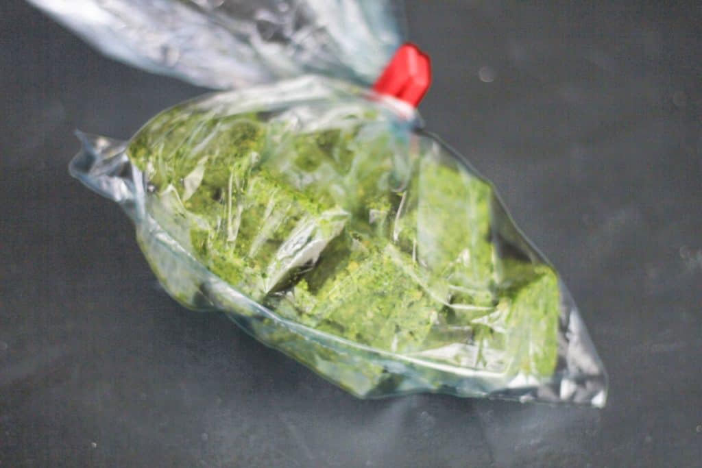 frozen cubes of wild garlic pesto stored in a freezer bag