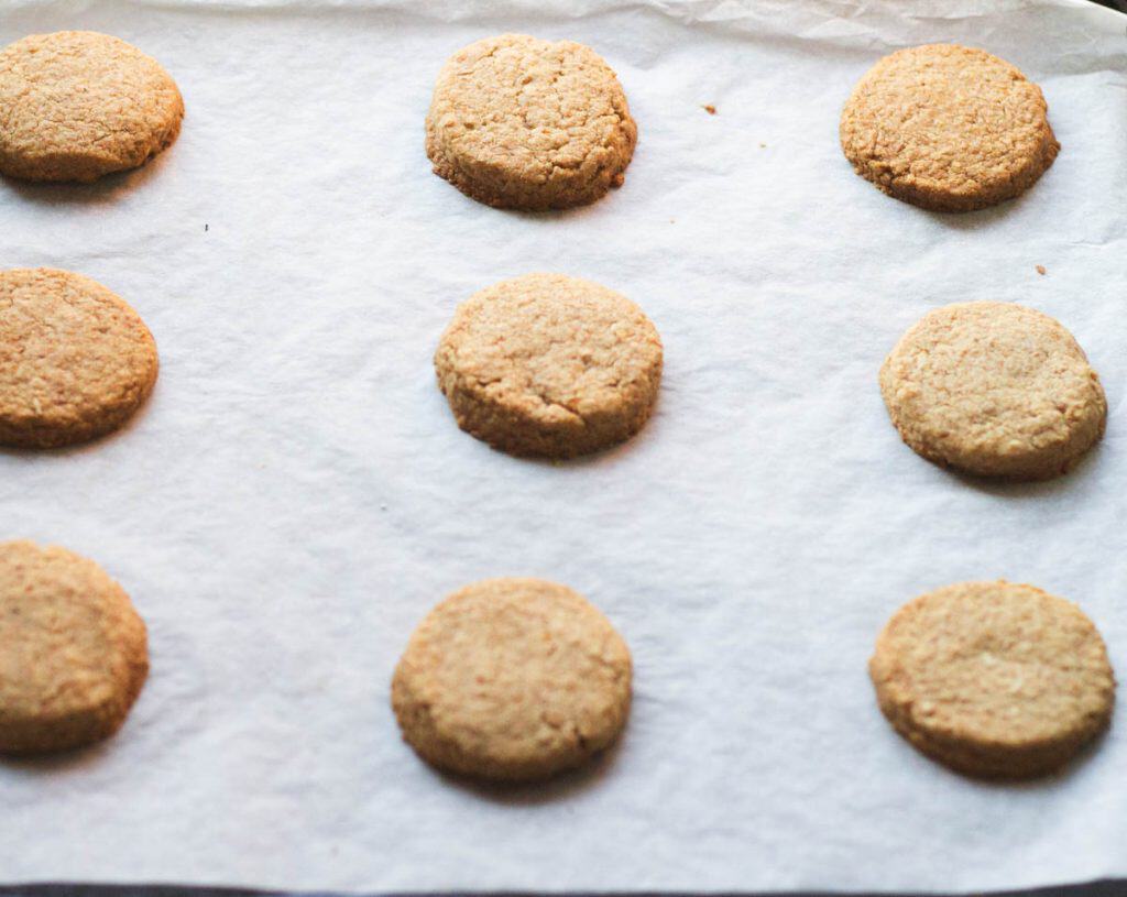 golden brown whole wheat shortbread cookies on a cookie sheet lined with parchment paper