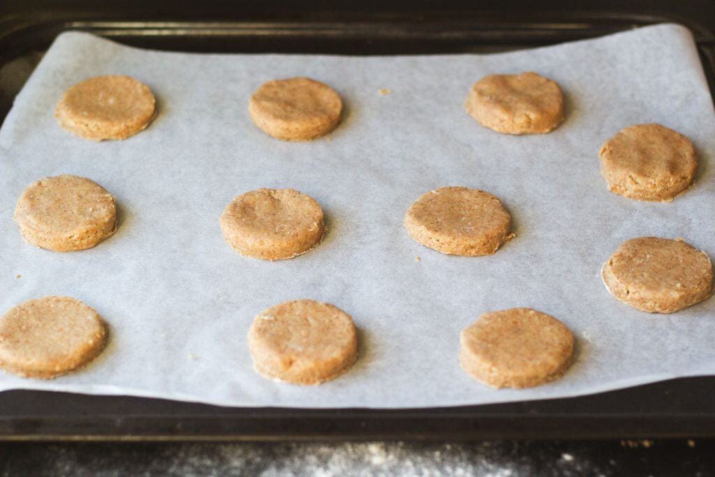 whole wheat shortbread cookies placed on a cookie sheet lined with parchment paper