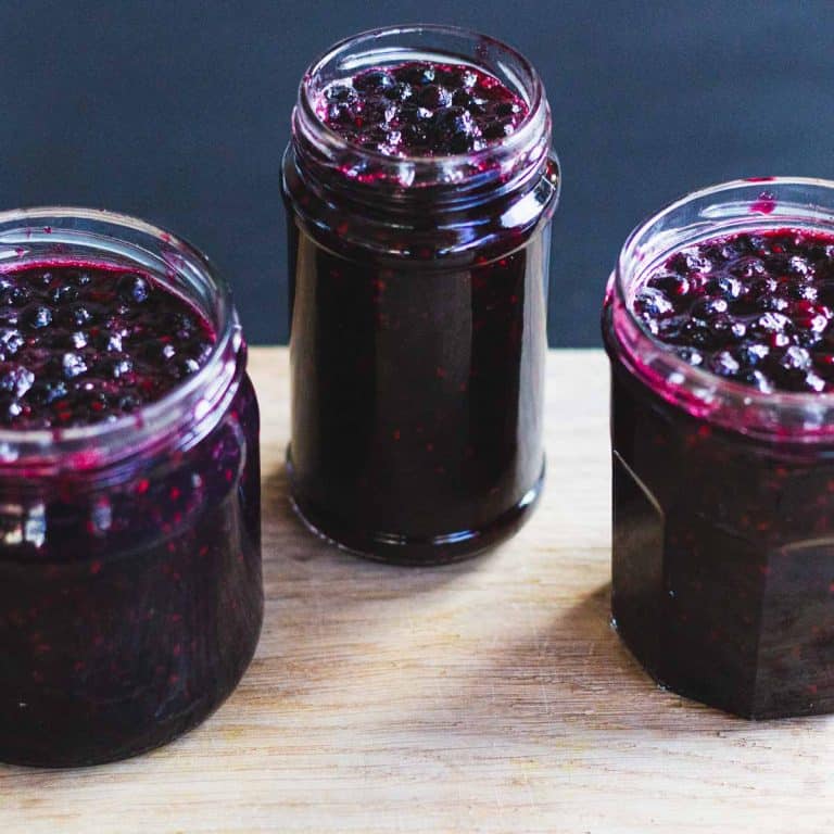 Three jars of Swedish Queens Jam on a wooden board