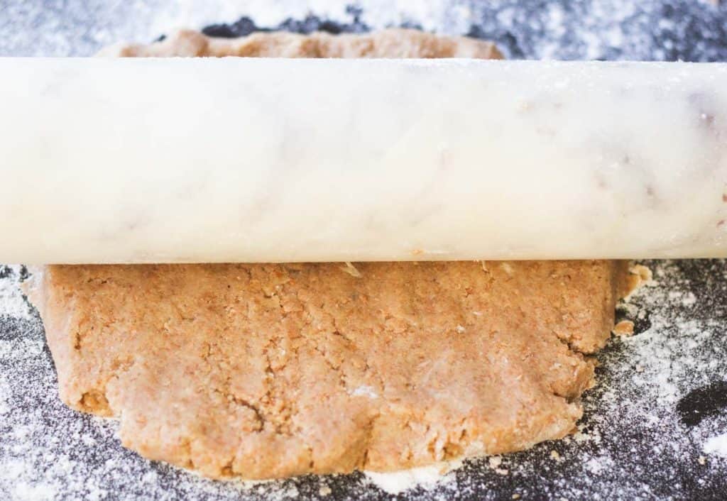 a marble rolling pin rolling out dough