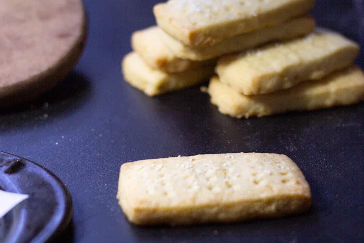 salted lemon shortbread cookie in front of a bunch of cookies