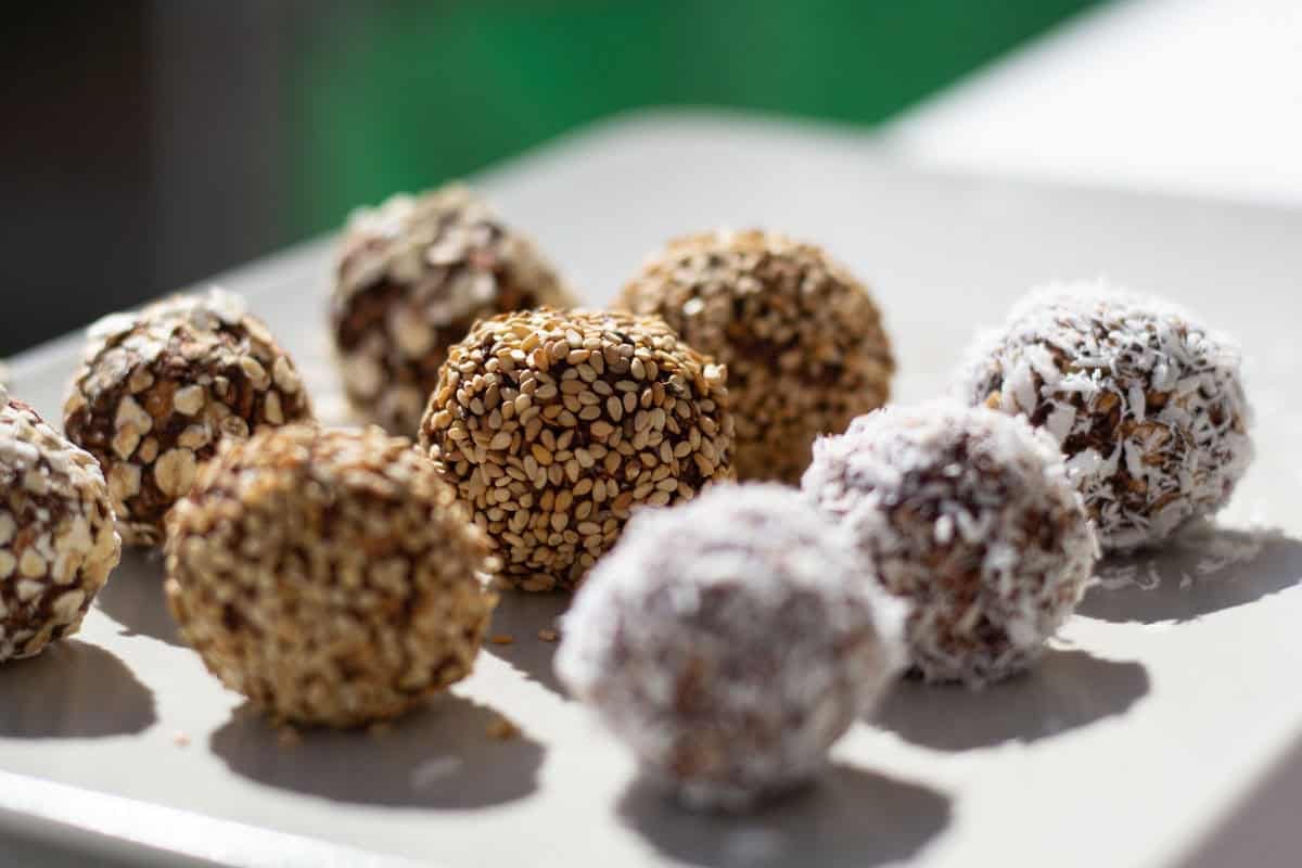 Swedish chocolate balls in a row. They are rolled in various toppings