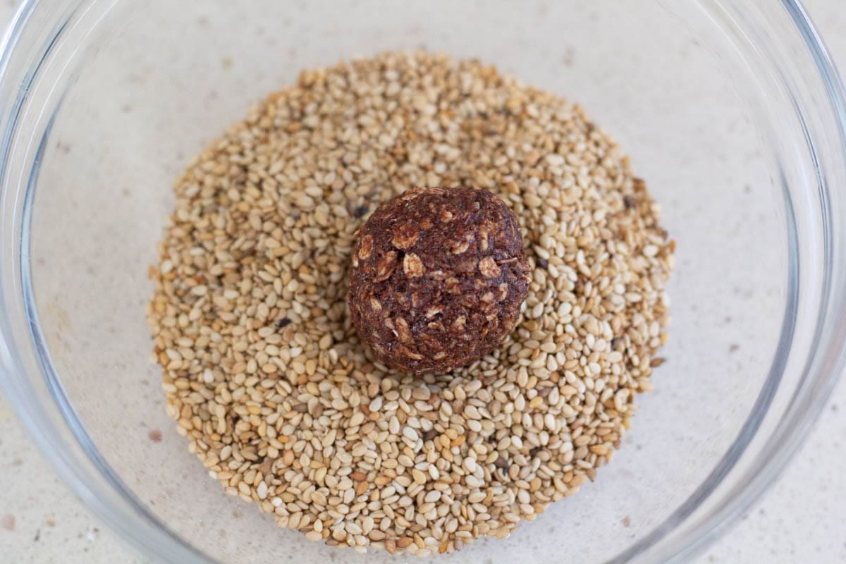 Swedish chokladball in a bowl of sesame seeds
