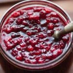 A spoon in Swedish Lingonberry Jam in a glass jar
