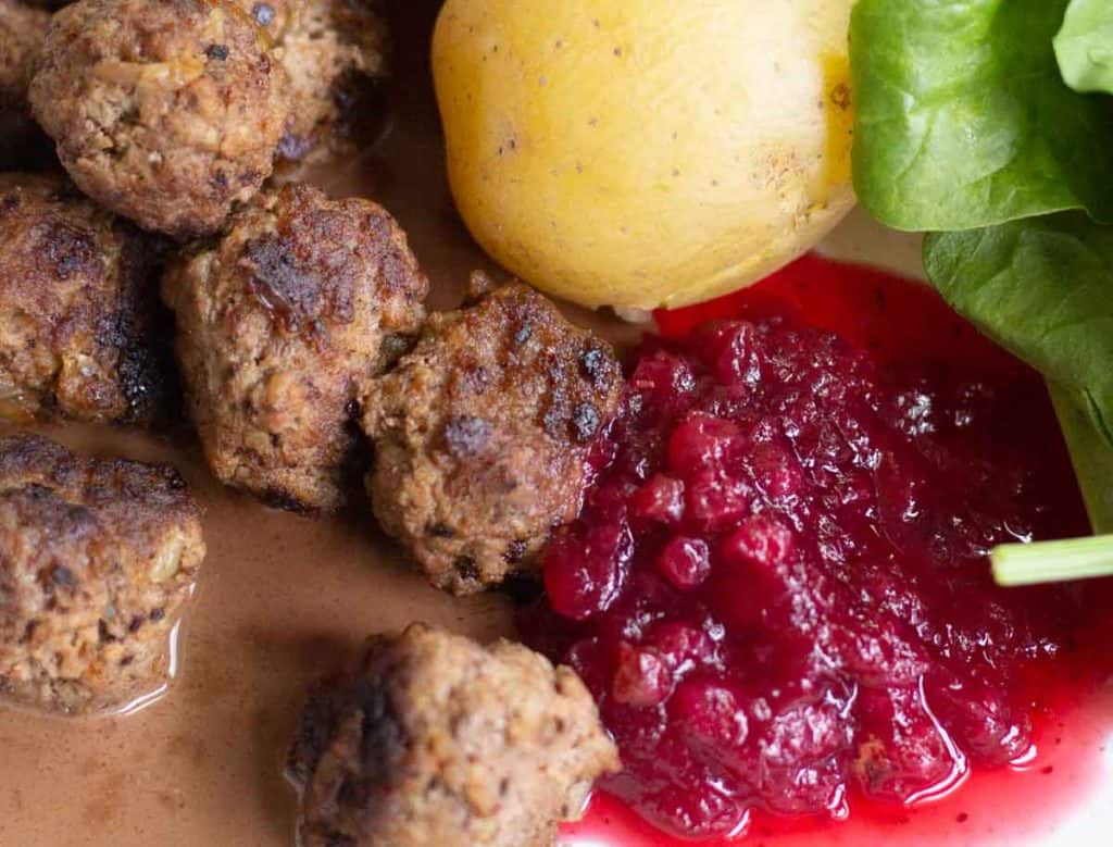 Swedish meatballs served wth boiled potatoes, salad and lingonberry jam