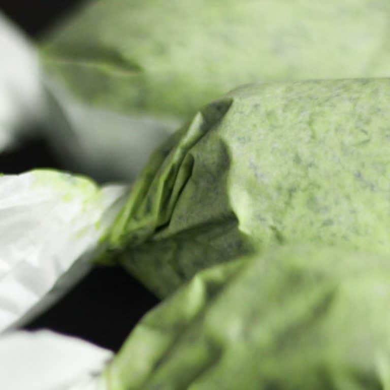 Wild garlic butter wrapped in parchement paper to form logs that are easy to freeze