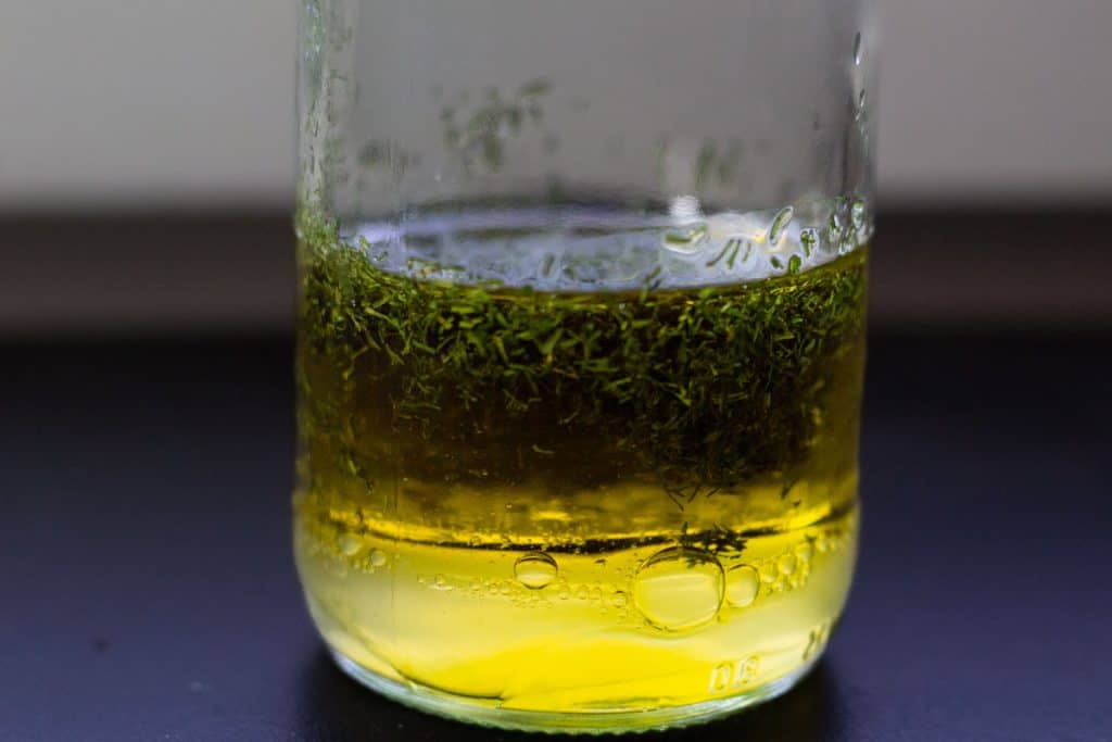 dill dressing in a glass bottle