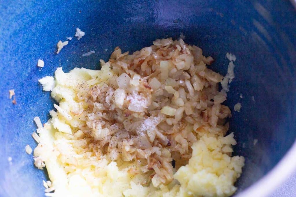 mashed potatoes, fried onions, salt and pepper in a large mixing bowl