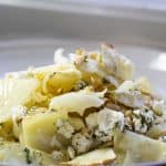 side view of warm roasted cababge salad served on a white ceramic plate