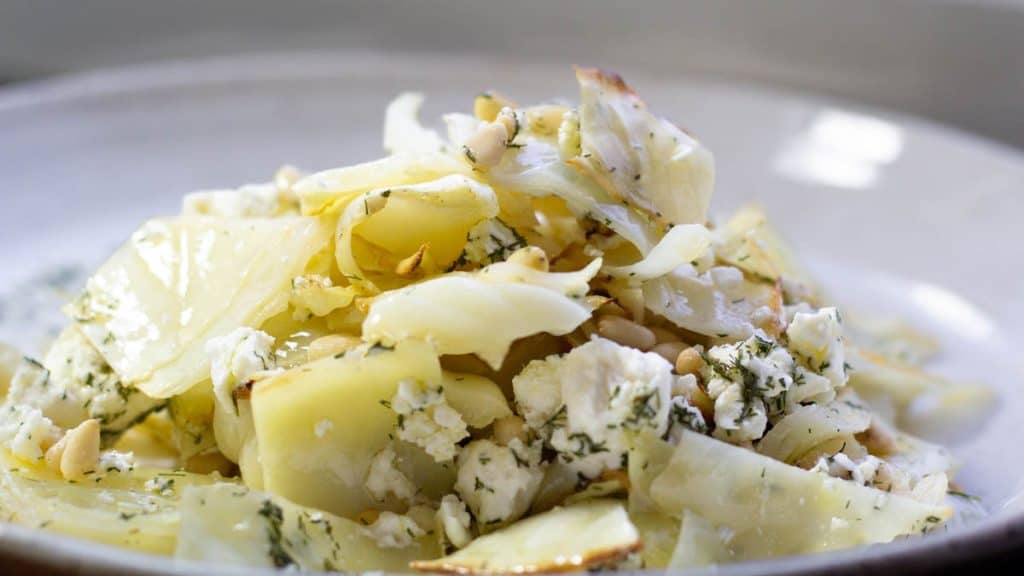 side view of roasted cabbage salad served on white plate