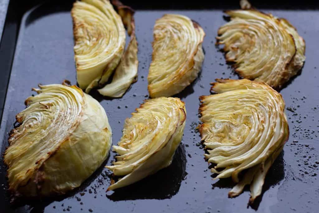 golden brown Roasted cabbage wedges on an oiled baking sheet