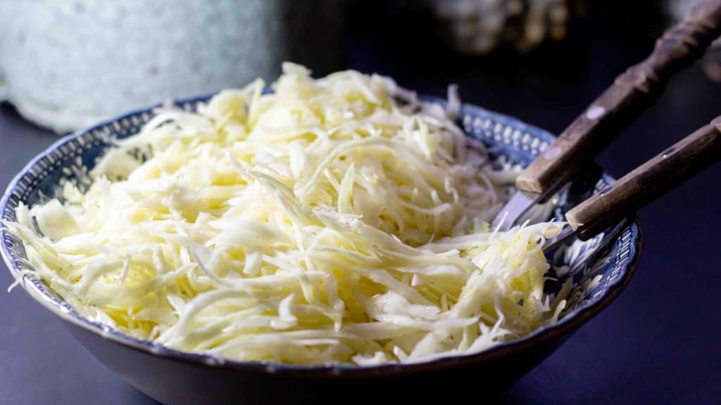 Side view of a vintage blue bowl filled with Swedish Pizza Sallad