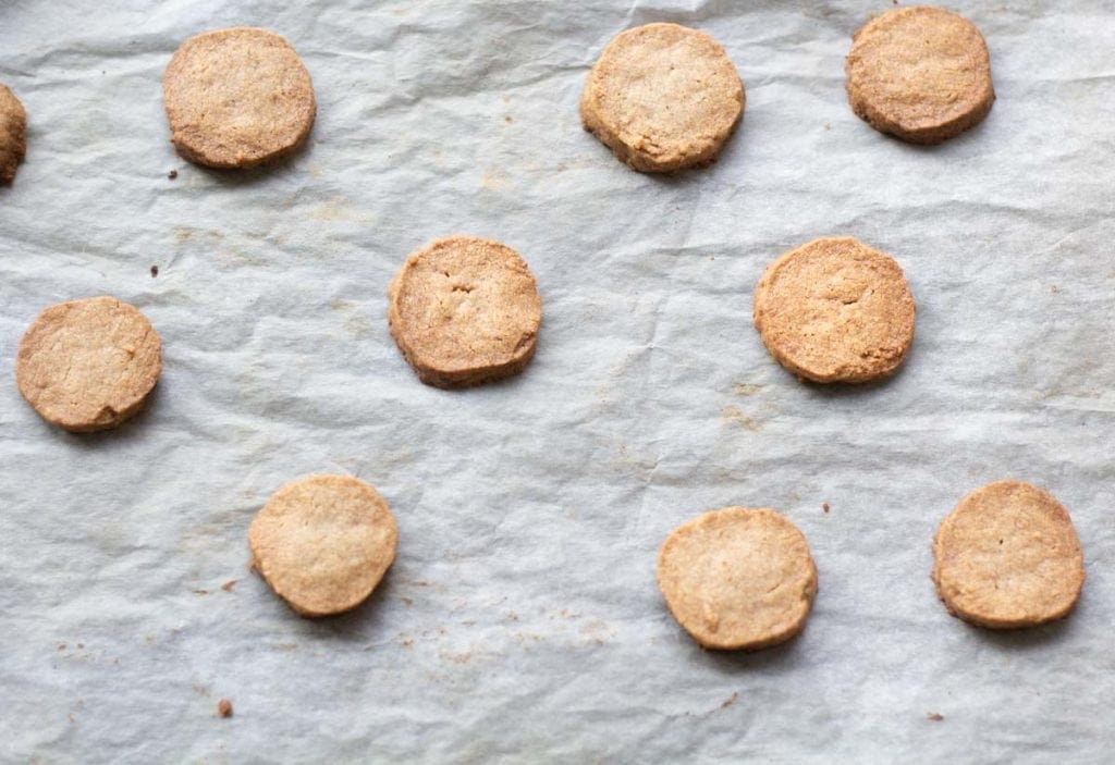 golden briwn gingerbread shortbread rounds on a baking tray