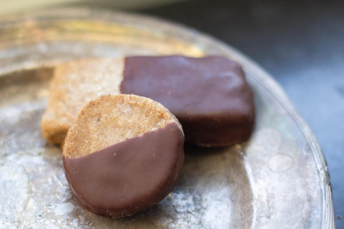 chocolate dipped gingerbread shotybread cookies on a silver tray