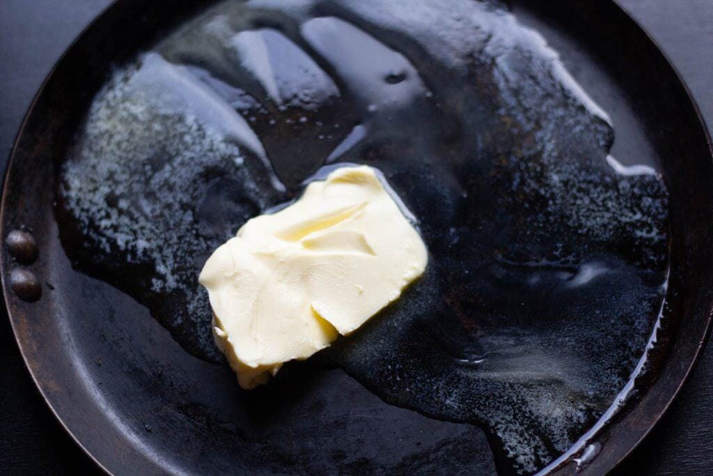 a knob of butter melting in a hot pan